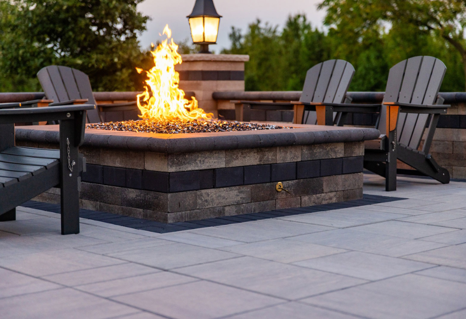 outdoor firepit in the evening with a lit fire
